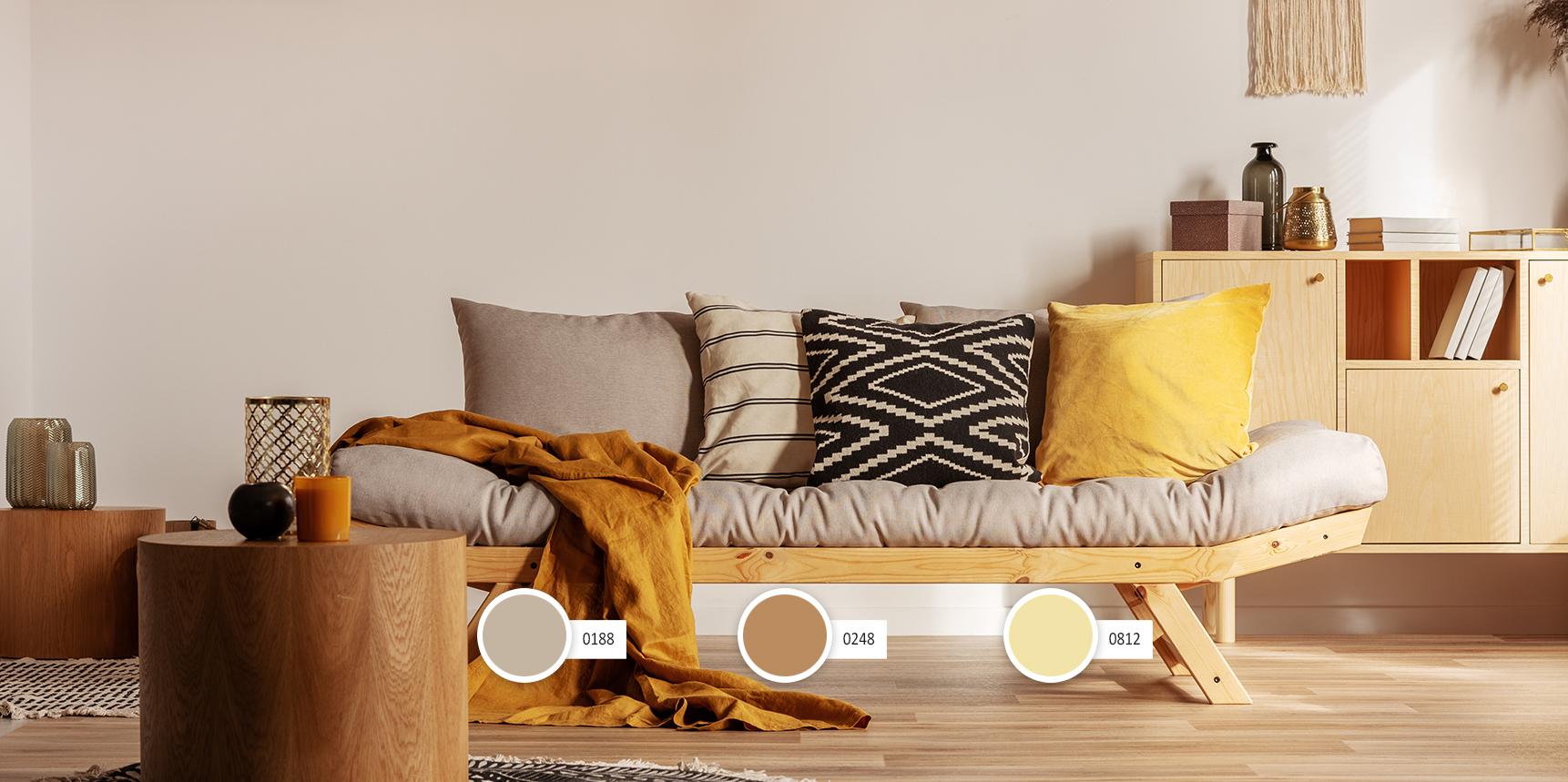 Scandinavian sofa with pillows and dark yellow blanket in bright living room interior with black chandelier